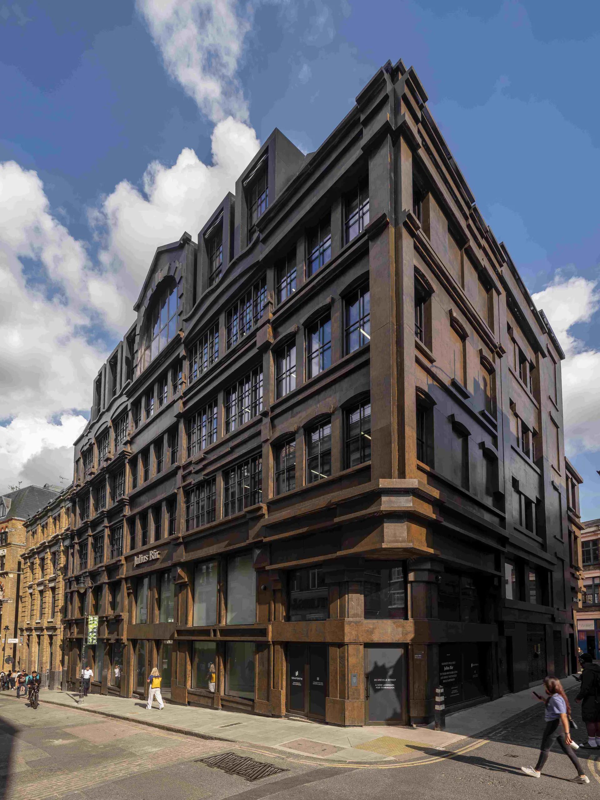 8 Bleeding Heart Yard on the corner of Greville Street, wrapped in a rust-brown folded aluminium screen modelled on the site's former buildings, Farringdon