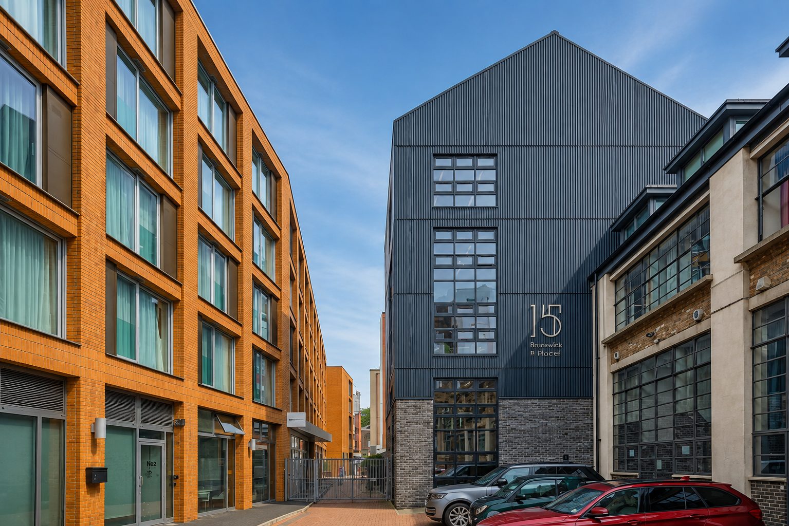 Black vertical timber cladding on the gabled upper floors of 15 Blue Lion Place above a dark brick base, Southwark