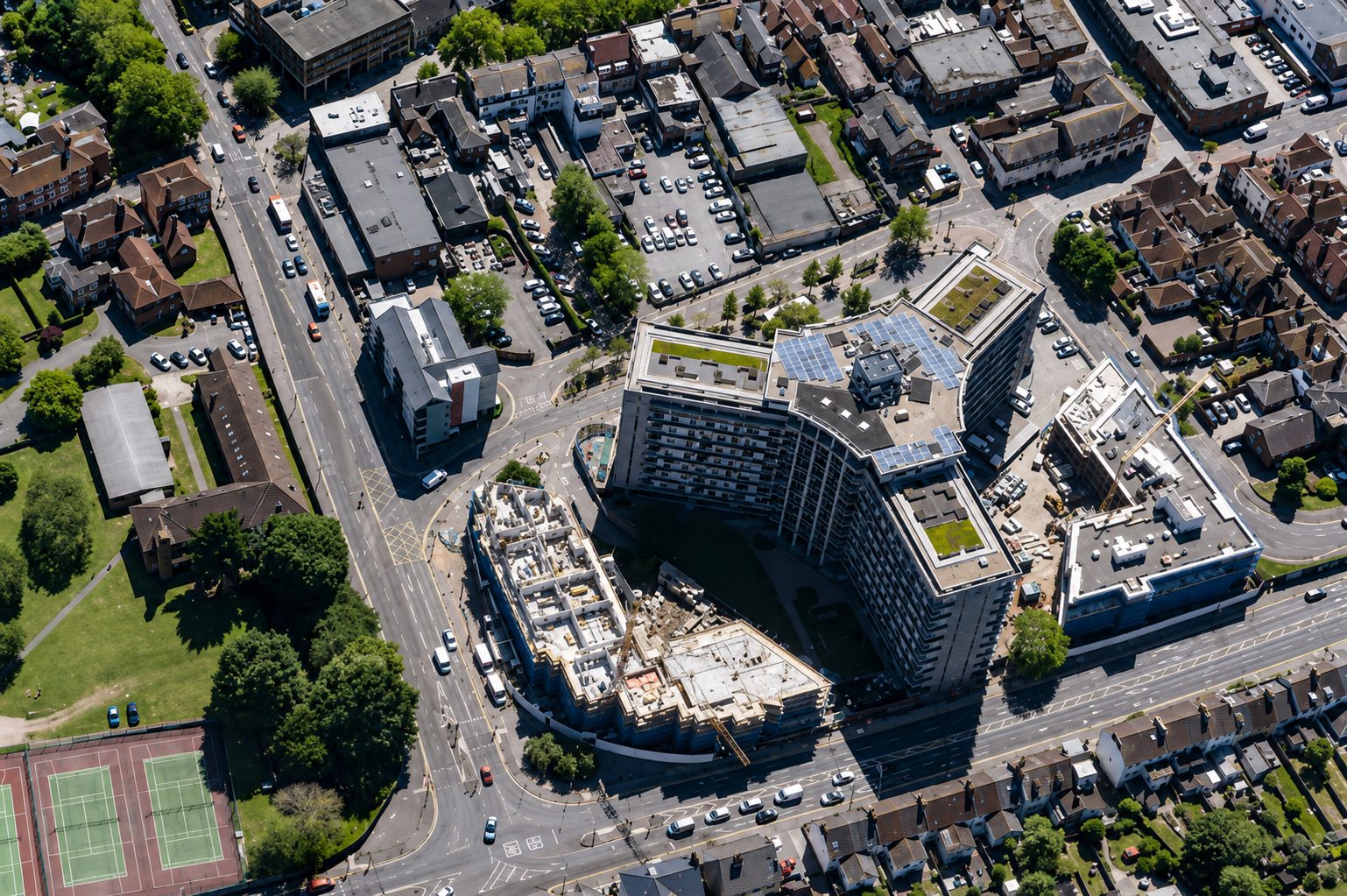Aerial photograph of the curved Panorama tower in Ashford with two new apartment wings under construction either side