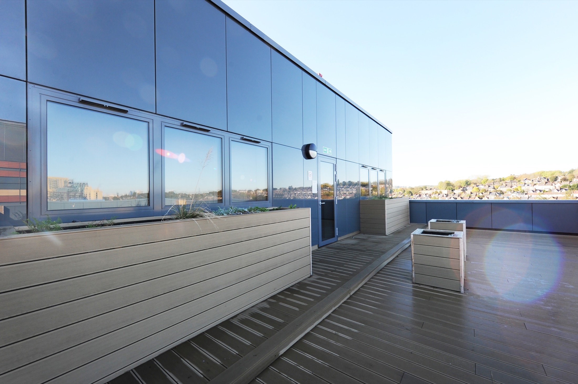 Riverdale House — rooftop terrace with composite decking and long-life cladding.